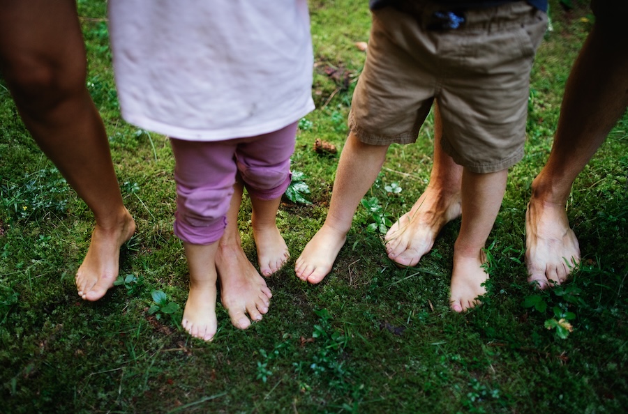 bare feet of family standing on mossy ground 2026 01 05 06 13 34 utc